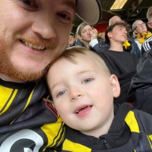 sam and his child at a football match